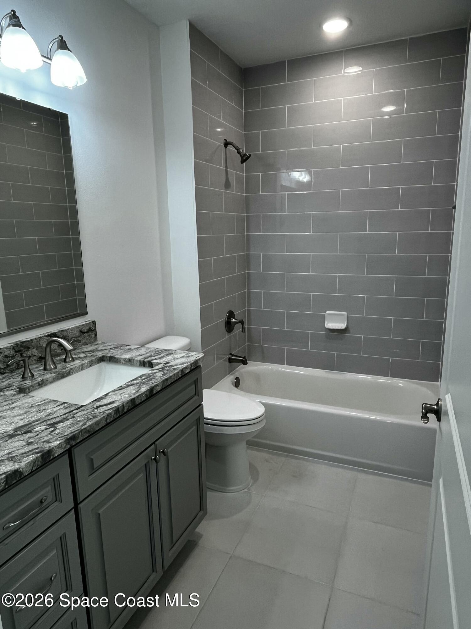 735 Pilot Lane, Unit 1009 Merritt Island, FL 32952 - Photo 8 of 21 a bathroom with a sink a toilet and shower