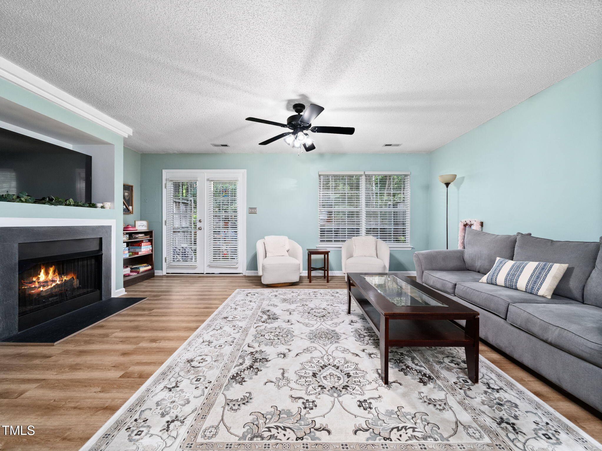 209 Climbing Ivy Court Cary, NC 27511 - Photo 11 of 24 a living room with furniture a fireplace and a flat screen tv