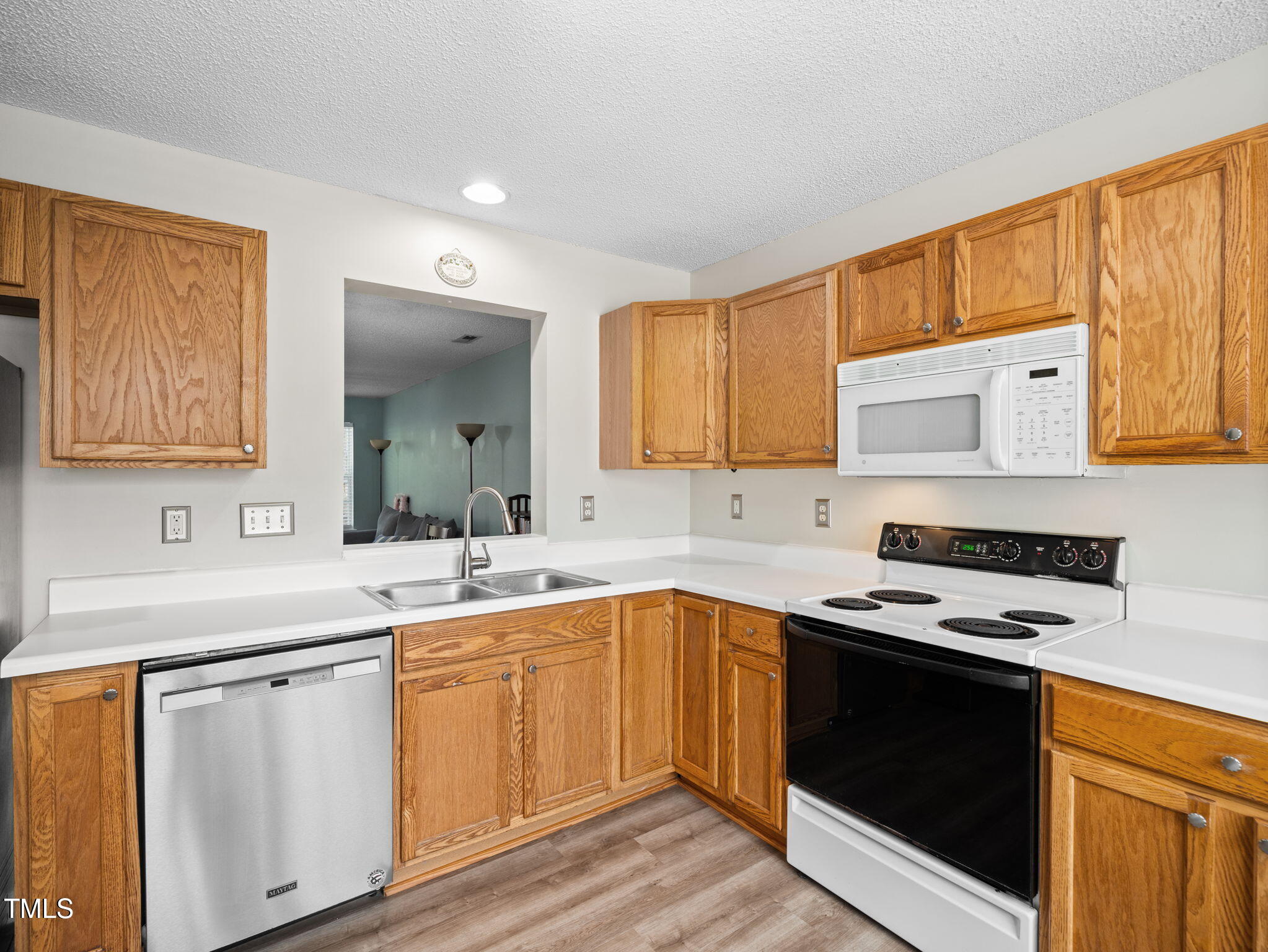 209 Climbing Ivy Court Cary, NC 27511 - Photo 2 of 24 a kitchen with a sink stove and cabinets