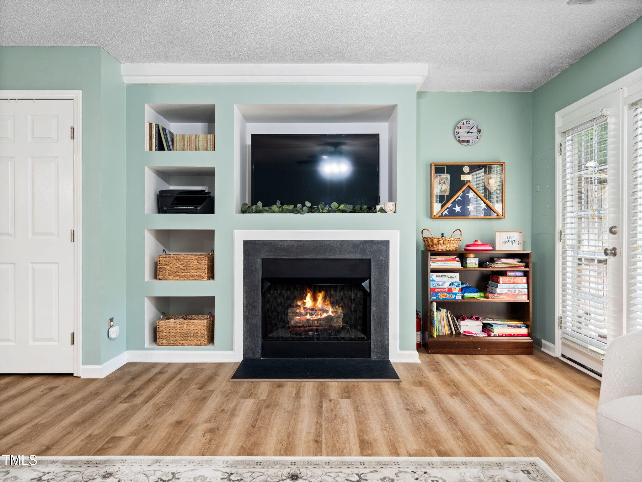 209 Climbing Ivy Court Cary, NC 27511 - Photo 4 of 24 a living room with fireplace and a fireplace