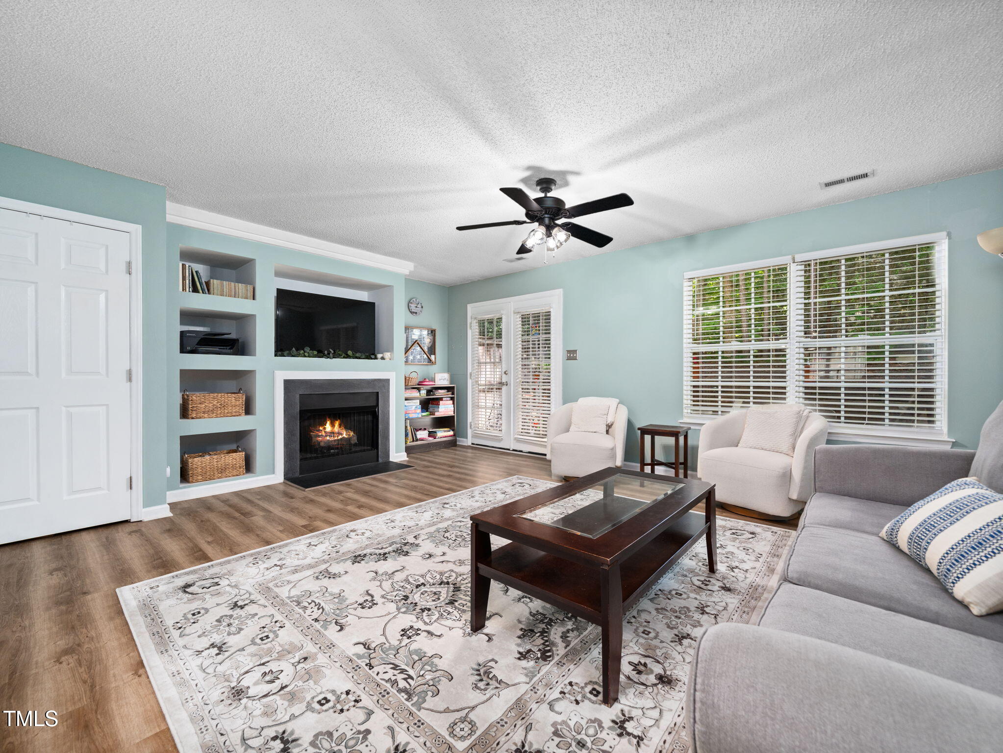209 Climbing Ivy Court Cary, NC 27511 - Photo 5 of 24 a living room with furniture a fireplace and a flat screen tv