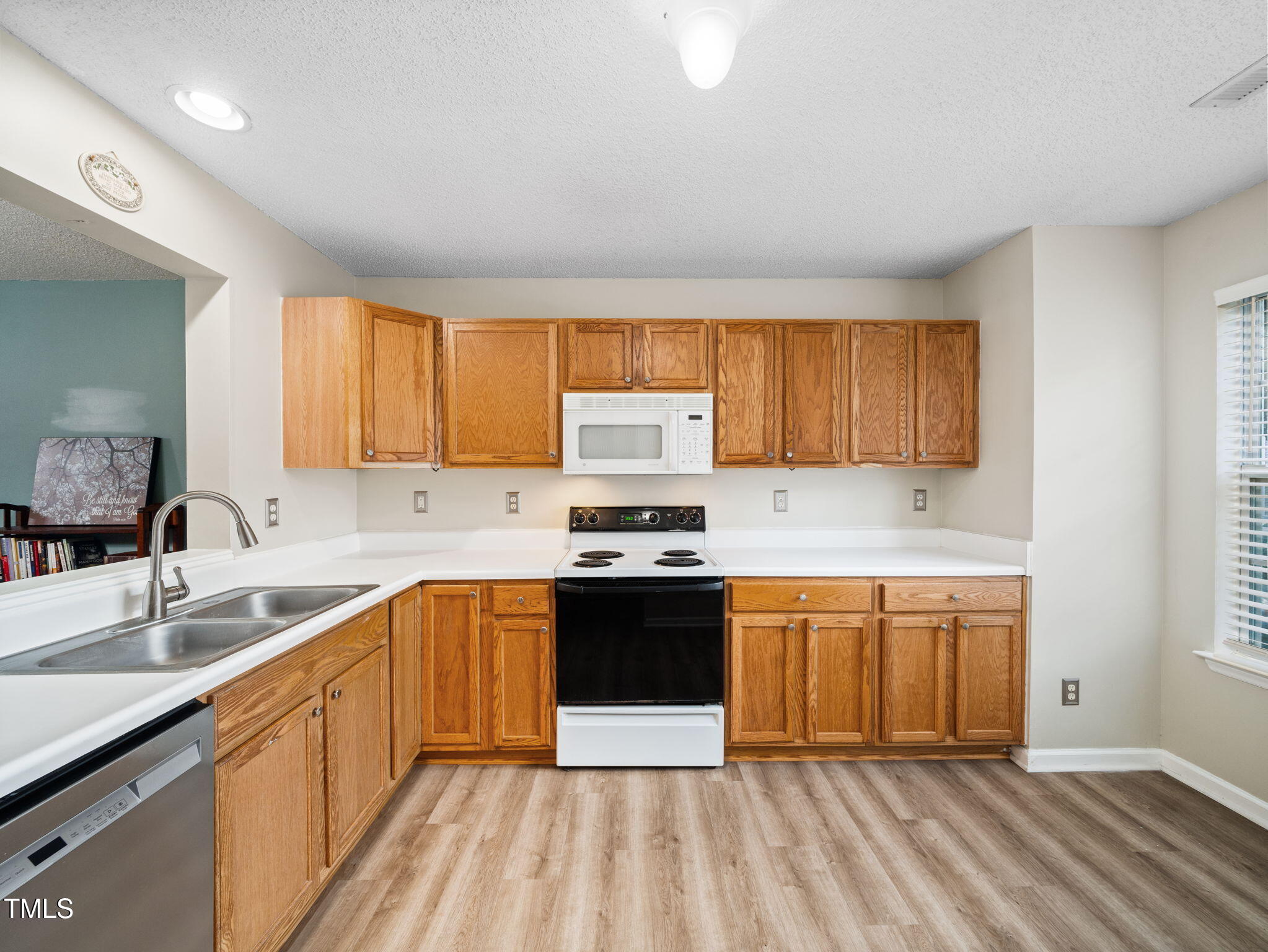 209 Climbing Ivy Court Cary, NC 27511 - Photo 6 of 24 a kitchen with stainless steel appliances granite countertop a sink stove and refrigerator