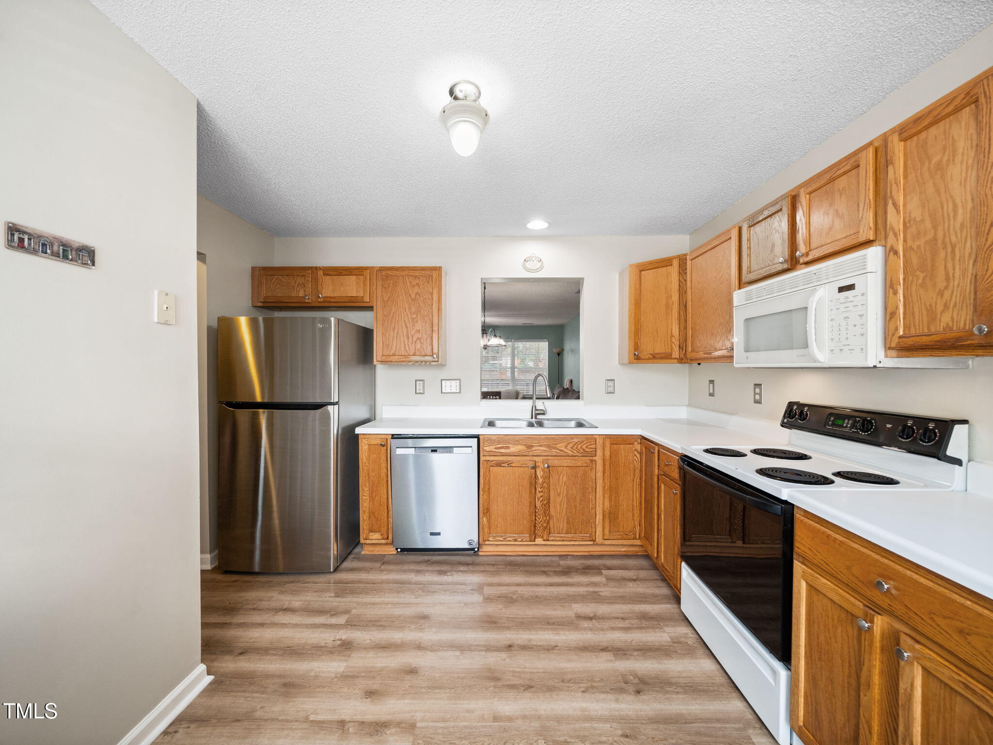 209 Climbing Ivy Court Cary, NC 27511 - Photo 7 of 24 a kitchen with stainless steel appliances granite countertop a refrigerator sink and stove