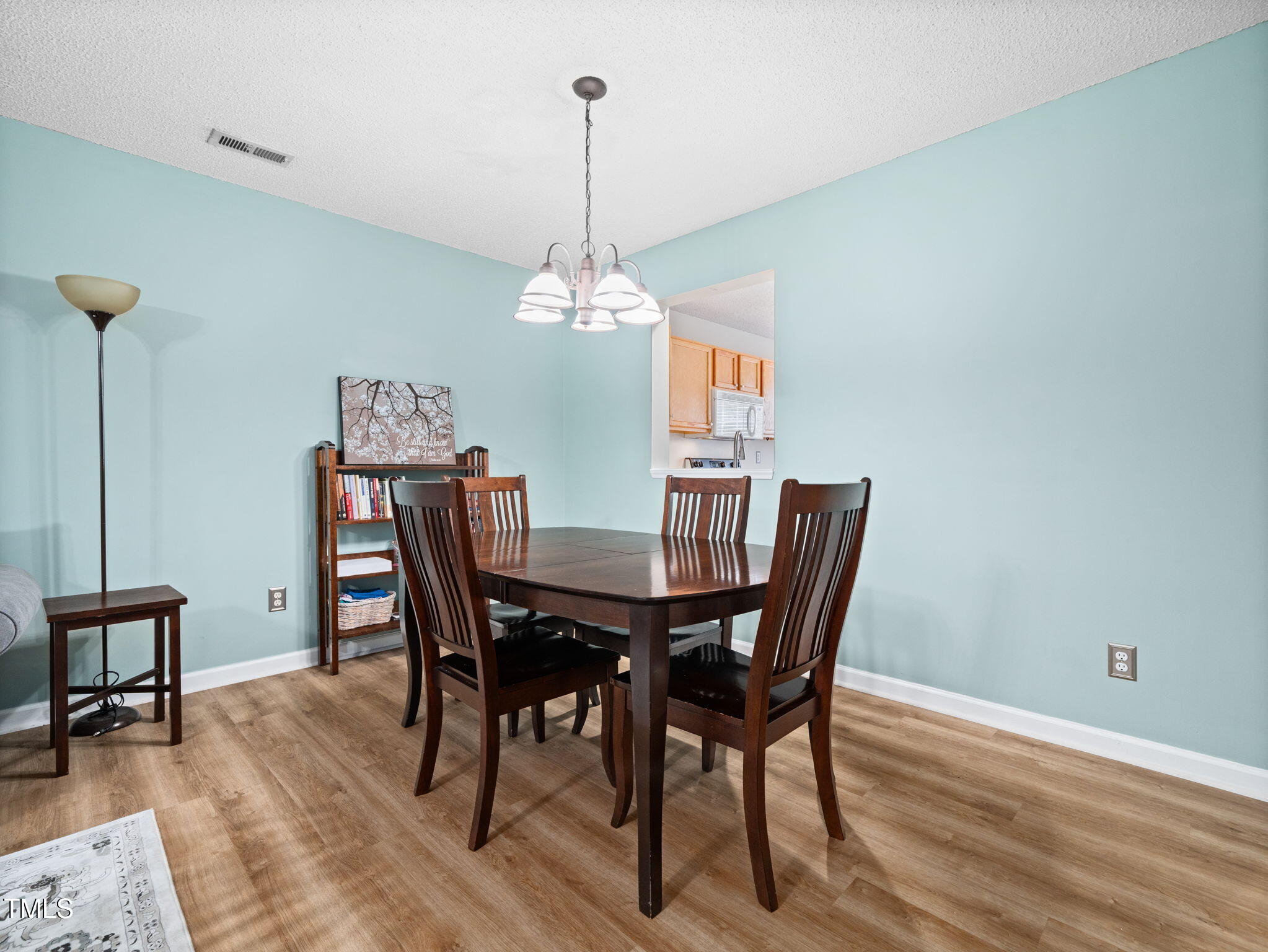 209 Climbing Ivy Court Cary, NC 27511 - Photo 9 of 24 a view of a dining room with furniture wooden floor and chandelier