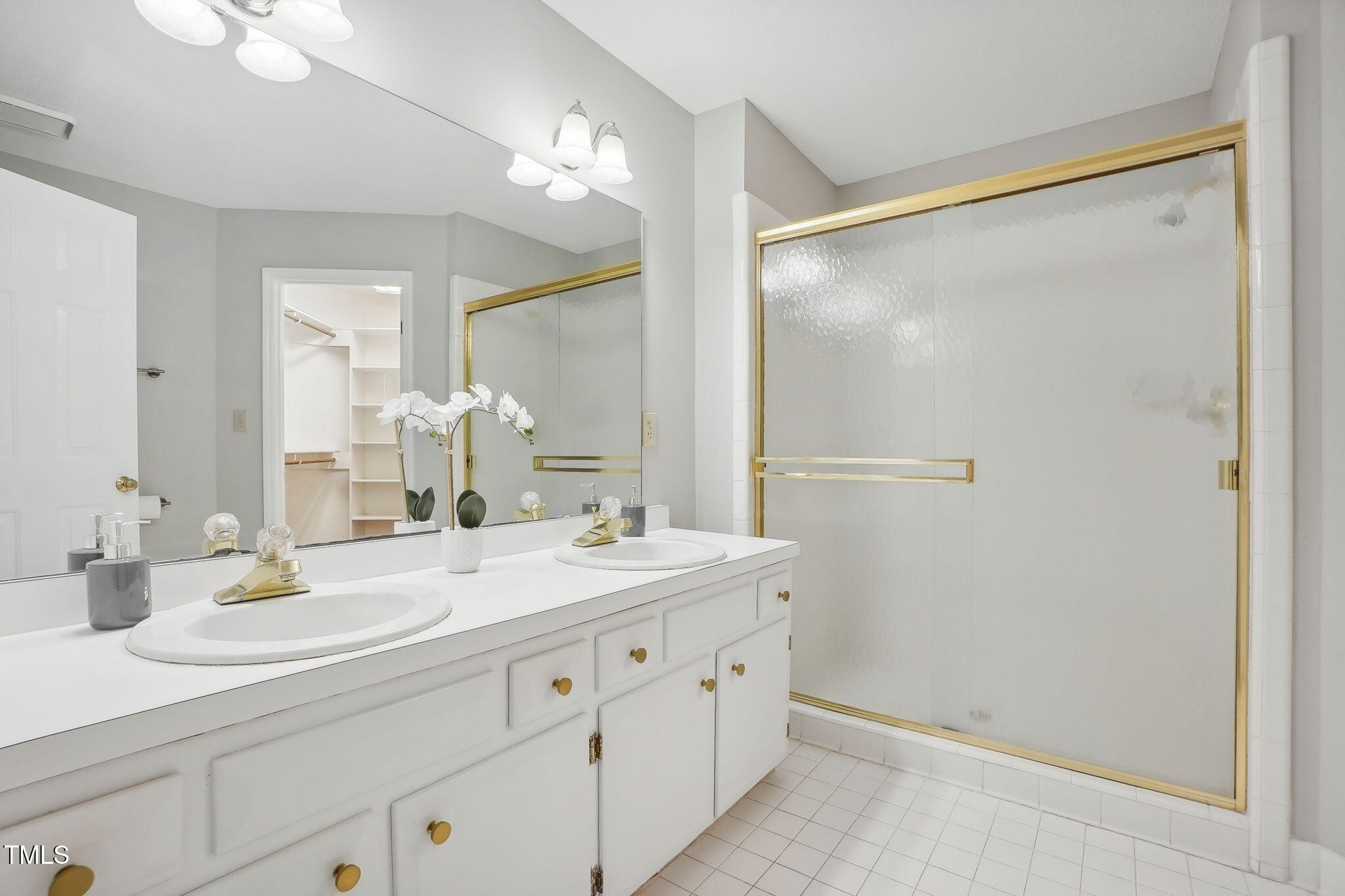 31 Renwick Court Raleigh, NC 27615 - Photo 18 of 32 a bathroom with a double vanity sink mirror and shower