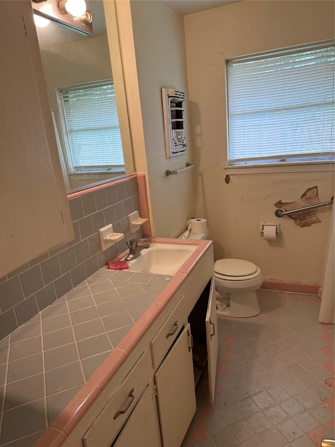 10906 Stover Street Houston, TX 77075 - Photo 15 of 19 a bathroom with a sink a toilet and a mirror