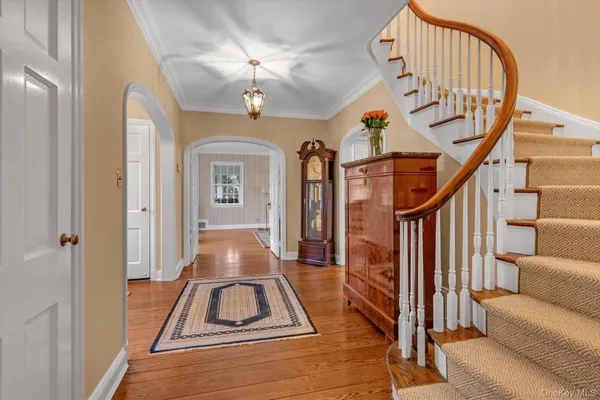 a view of entryway and hall with wooden floor