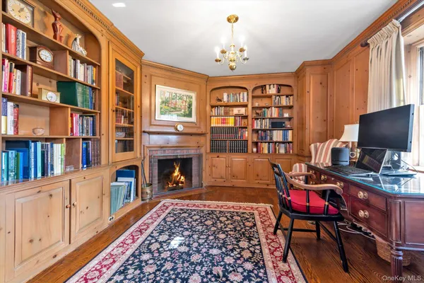 a living room with fireplace furniture and a book shelf