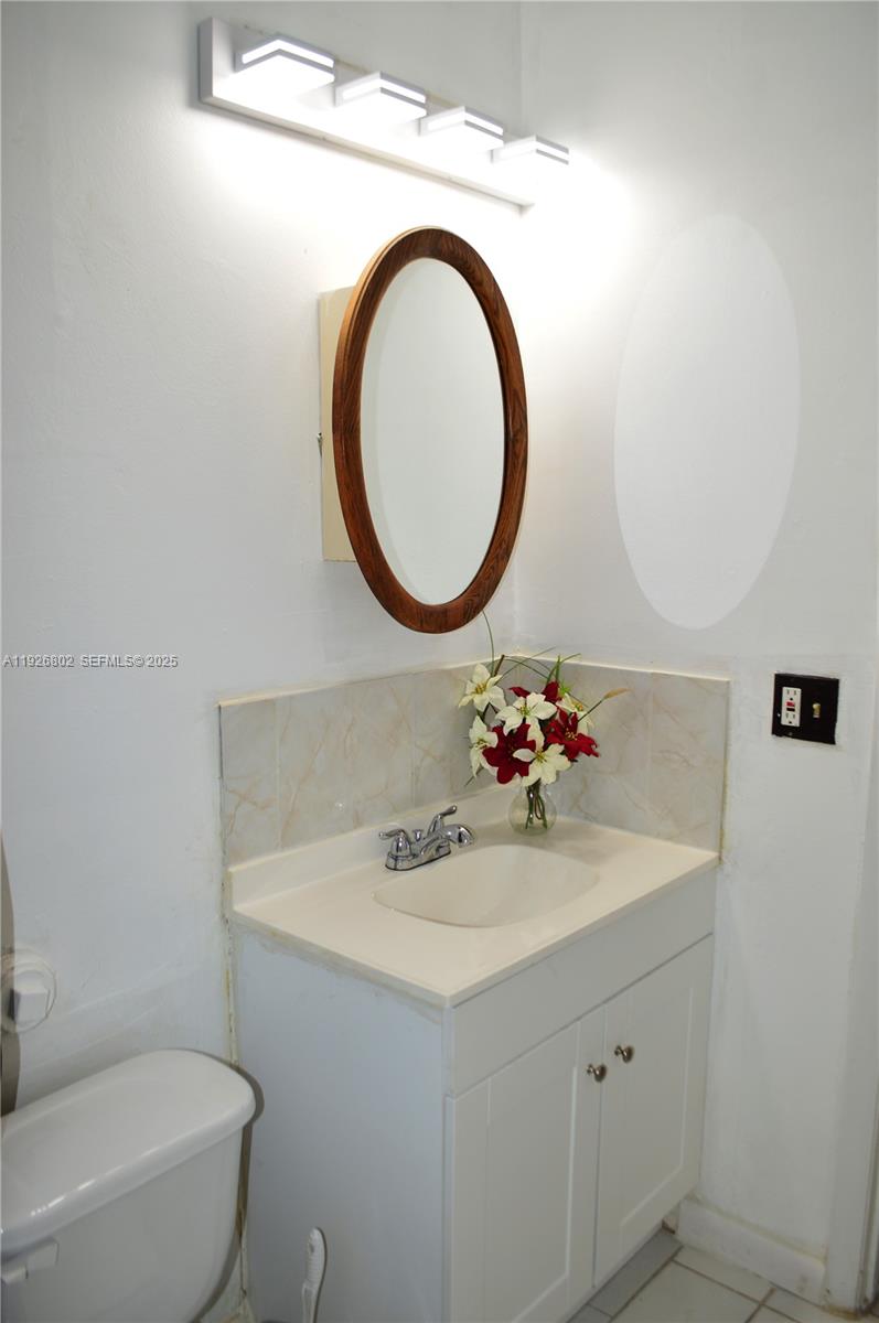274 Southwest 9th Street, Unit 2 Dania Beach, FL 33004 - Photo 11 of 24 a bathroom with a sink and a mirror