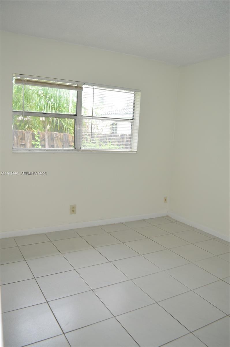 274 Southwest 9th Street, Unit 2 Dania Beach, FL 33004 - Photo 13 of 24 an empty room with a window