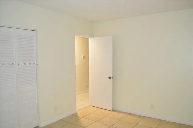 a view of a house with a yard and potted plants