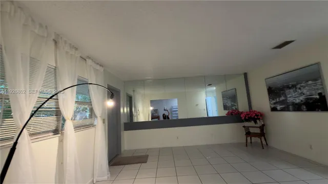 a view of a hallway to a livingroom and a livingroom with furniture