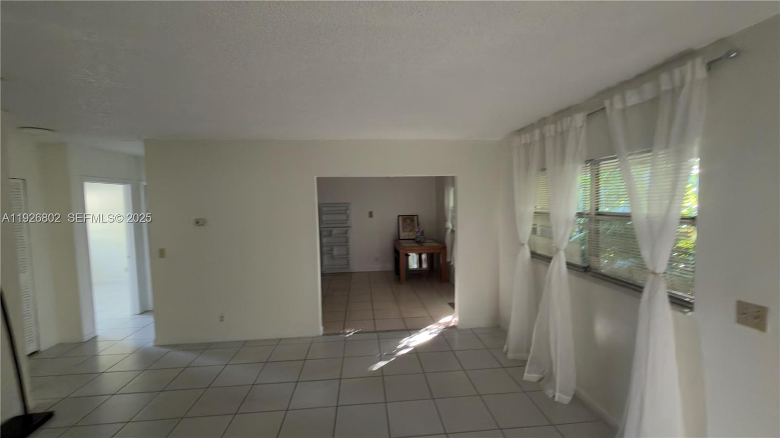 274 Southwest 9th Street, Unit 2 Dania Beach, FL 33004 - Photo 7 of 24 a view of a hallway to a livingroom and a livingroom with furniture