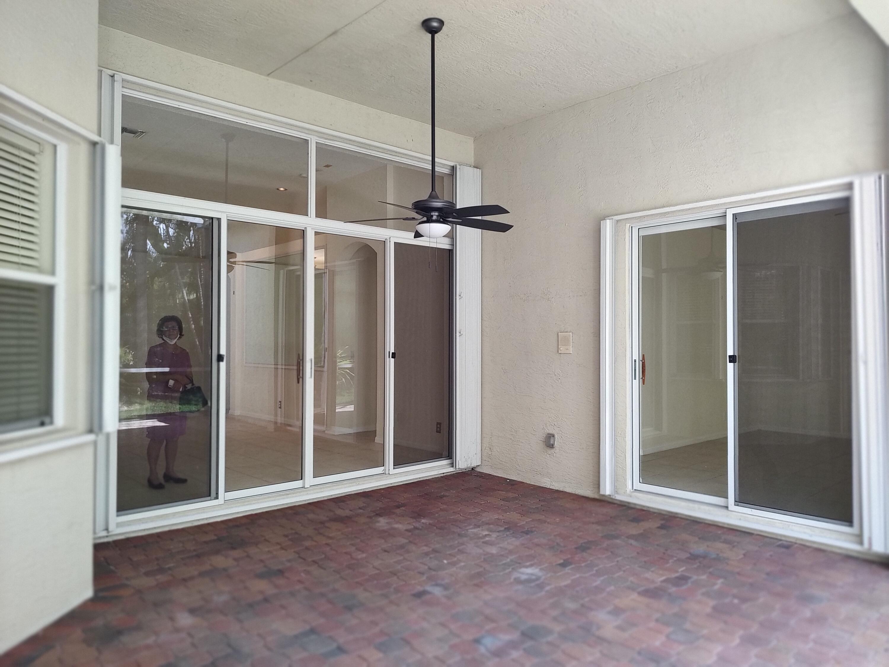 11241 Sea Grass Circle Boca Raton, FL 33498 - Photo 17 of 33 a view of a room with a large window and chandelier