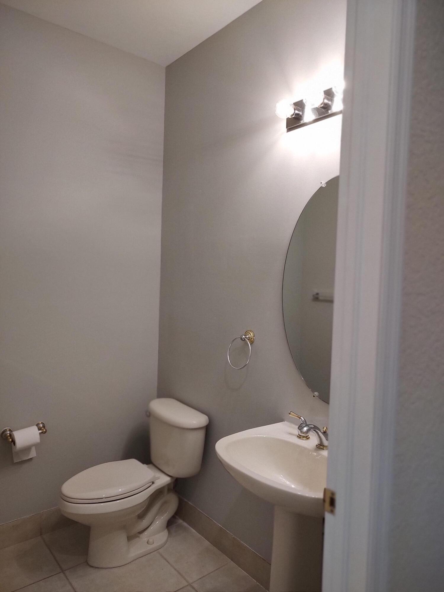 11241 Sea Grass Circle Boca Raton, FL 33498 - Photo 26 of 33 a bathroom with a toilet a sink and mirror