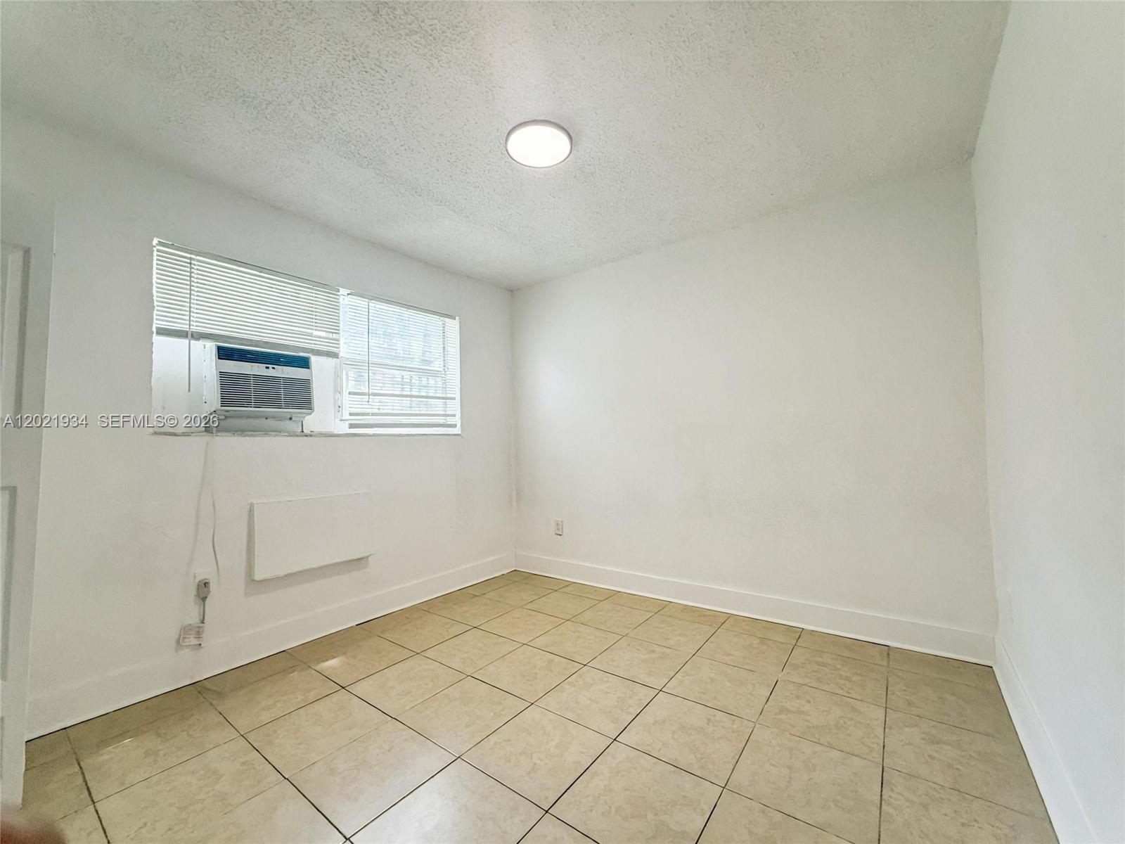 220 Northwest 11th Terrace, Unit 2 Miami, FL 33136 - Photo 7 of 9 an empty room with windows
