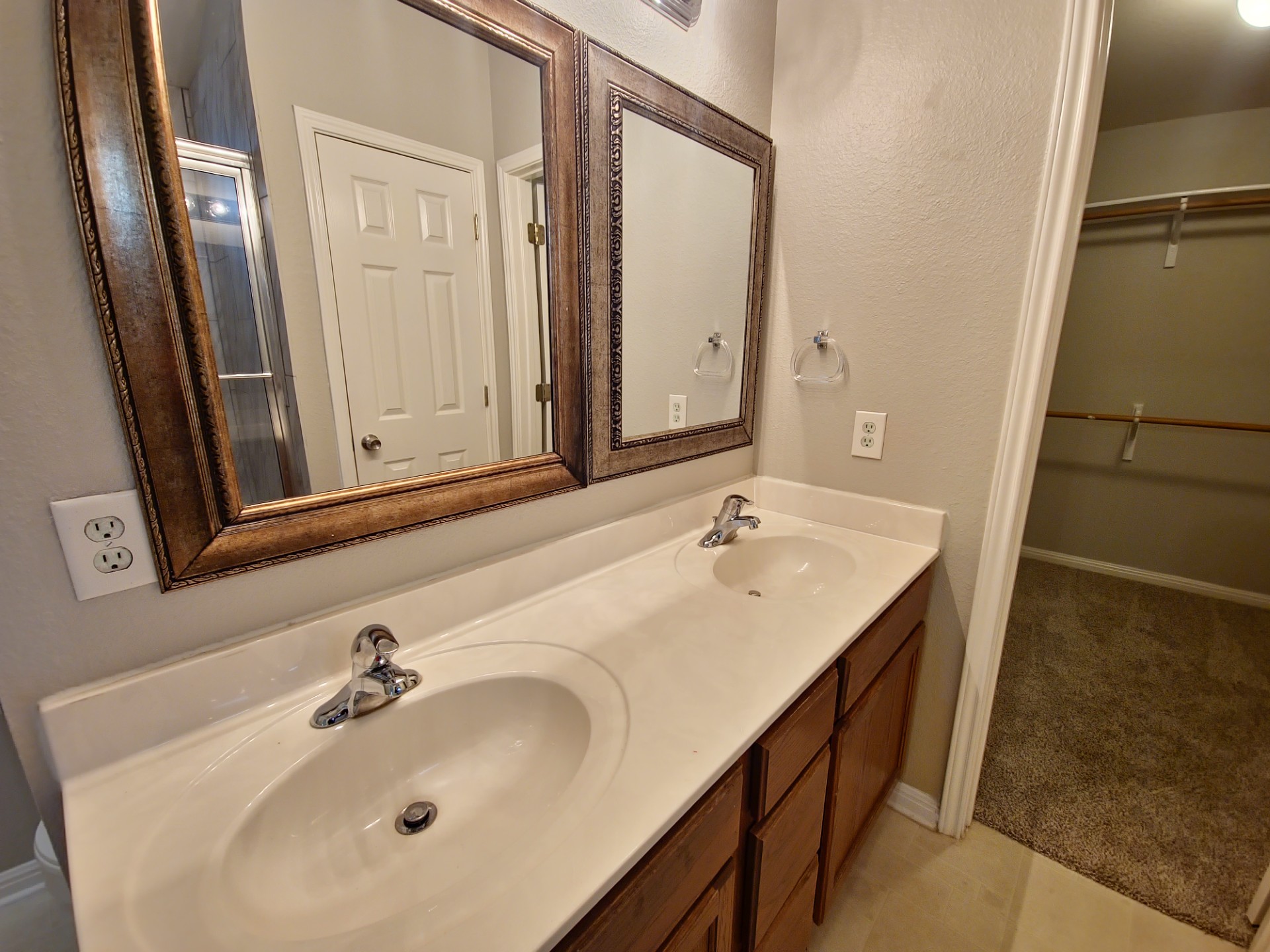 107 Orange Tree Lane Georgetown, TX 78626 - Photo 10 of 16 Double vanities and framed mirrors enhance this well-appointed primary bathroom.