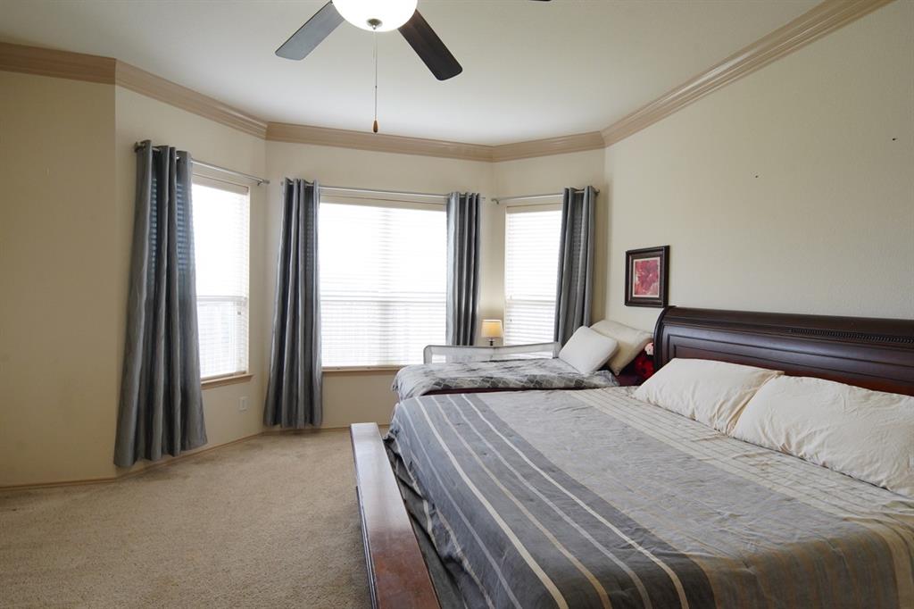 4508 Fox Rio Trail Arlington, TX 76017 - Photo 18 of 28 a bedroom with a large bed and a large window
