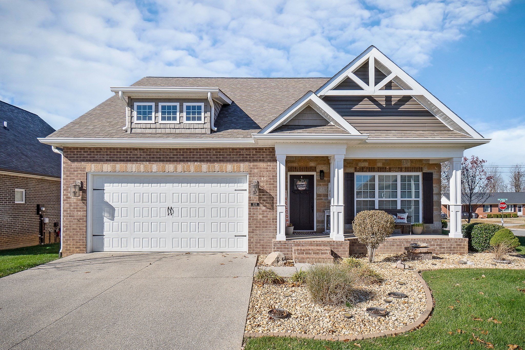 a front view of a house with garden