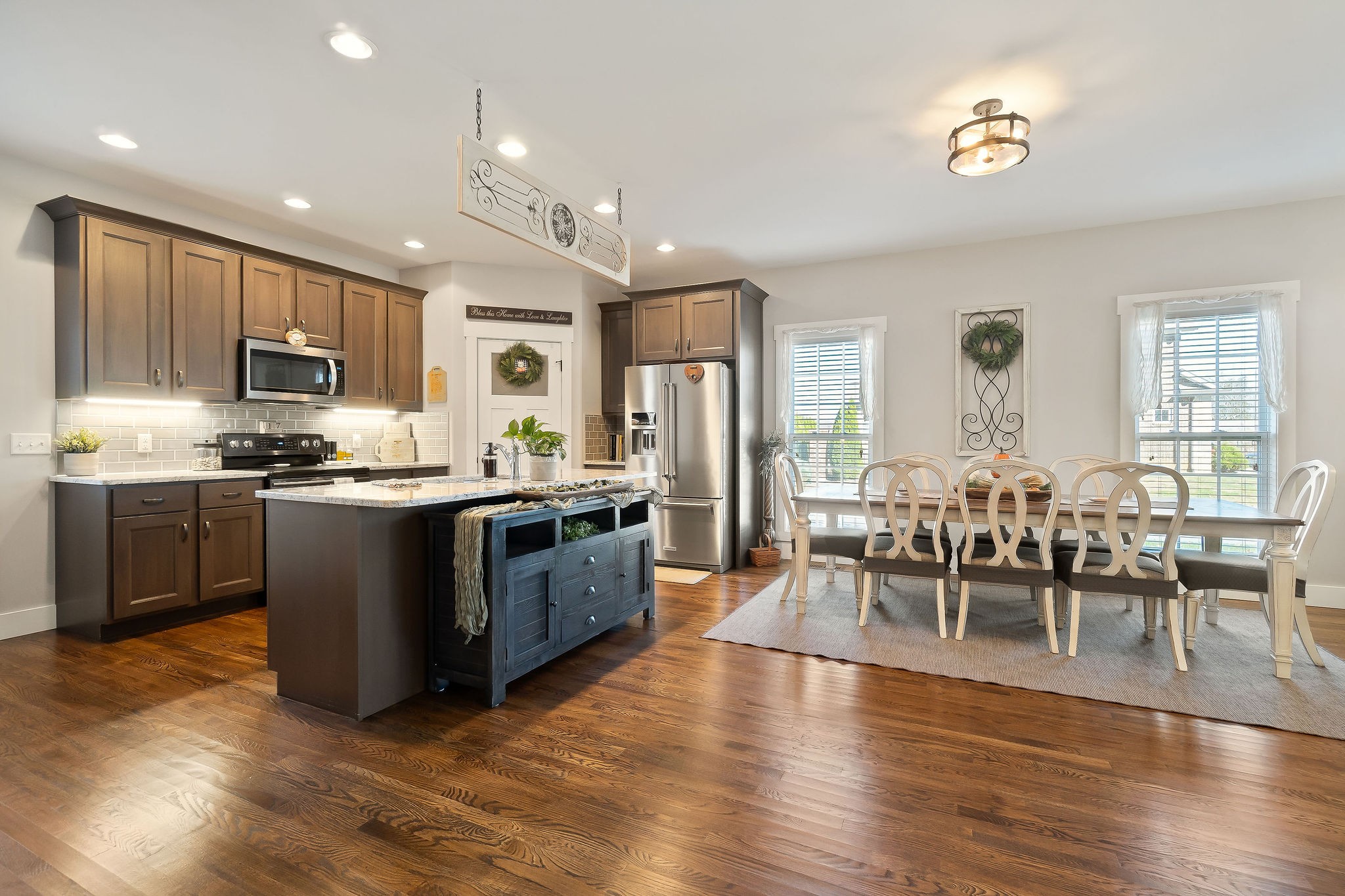 1138 Old Sparta Road Cookeville, TN 38506 - Photo 6 of 39 a large open kitchen with a refrigerator a stove a dining table and chairs