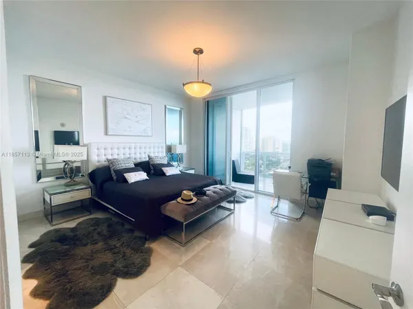 a living room with furniture a chandelier and a window