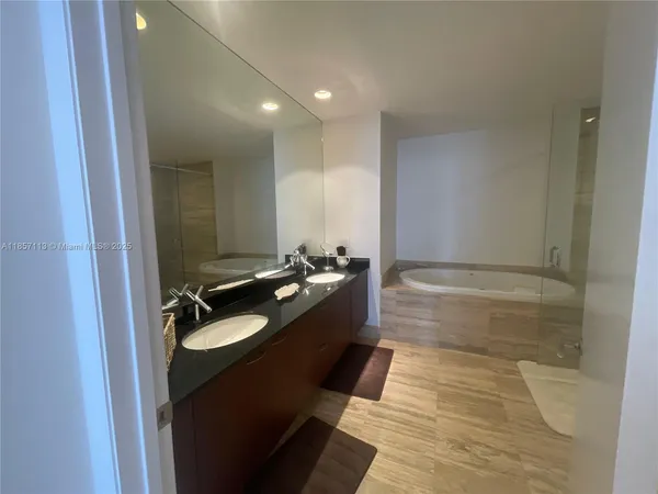 a bathroom with a granite countertop sink