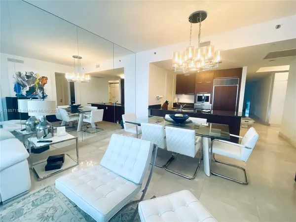 a living room with furniture or chandelier and a wooden floor