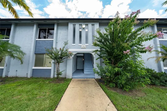 a front view of a house with swimming pool and outdoor seating