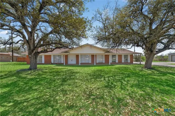 a front view of a house with yard and green space