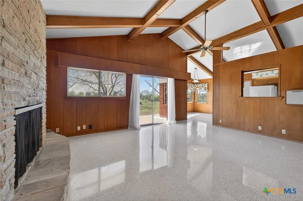 a view of a room with wooden floor and windows