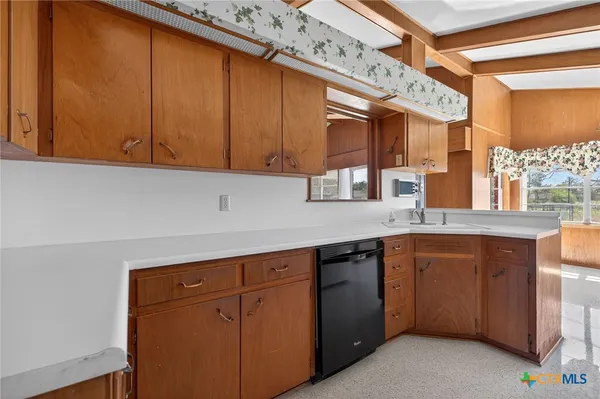 a kitchen with stainless steel appliances granite countertop a sink and cabinets