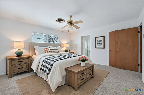 a bedroom with a bed and a chandelier