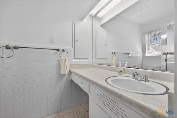 a bathroom with a sink and a mirror