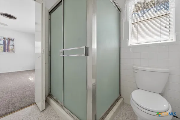 a white toilet sitting next to a bathroom sink