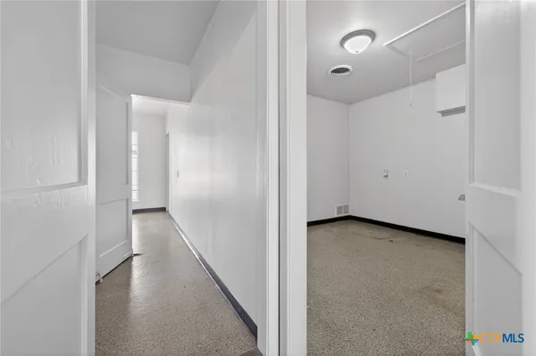 a view of a hallway with wooden floor