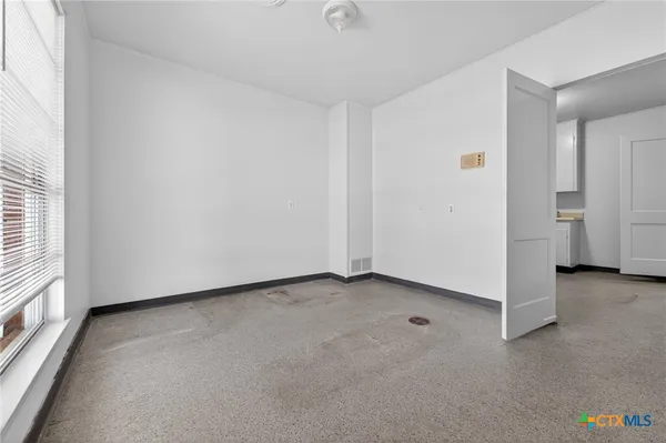 a view of an empty room with a window