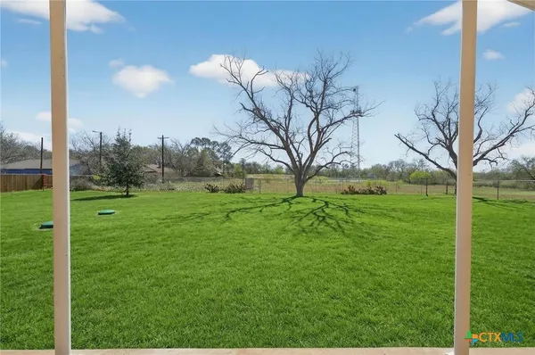 a view of grassy field with trees