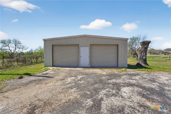 a view of a house with a yard and garage