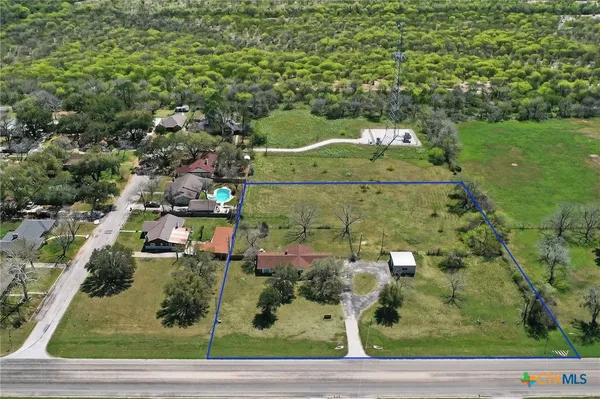 an aerial view of a houses with yard