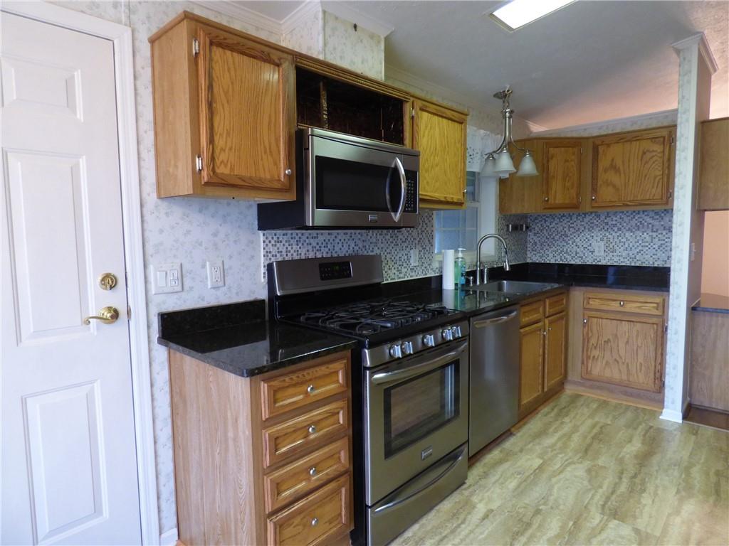 383 Eagle Lane Apollo, PA 15613 - Photo 3 of 25 a kitchen with stainless steel appliances a stove a microwave a sink and cabinets
