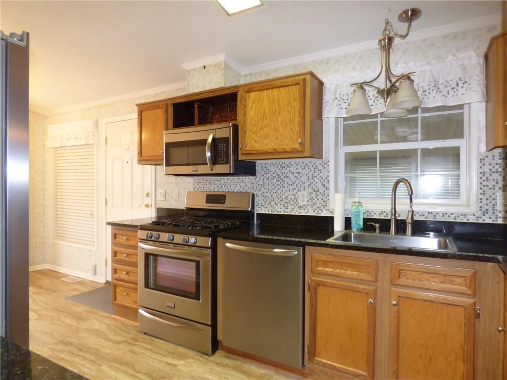383 Eagle Lane Apollo, PA 15613 - Photo 4 of 25 a kitchen with stainless steel appliances granite countertop a stove a sink and a microwave