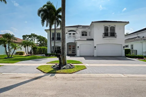 a front view of a house with a yard garage and outdoor seating