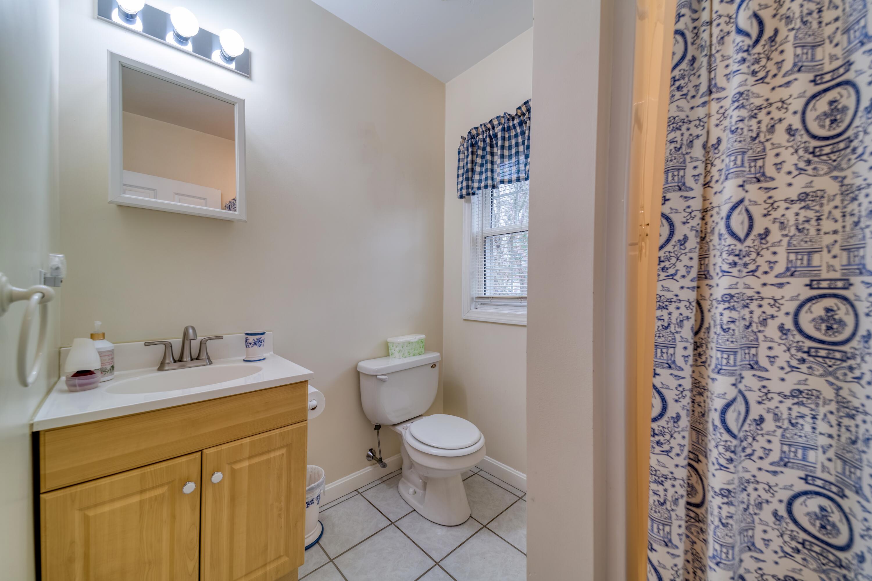 331 Cotuit Road Mashpee, MA 02649 - Photo 10 of 22 a bathroom with a sink toilet vanity and mirror