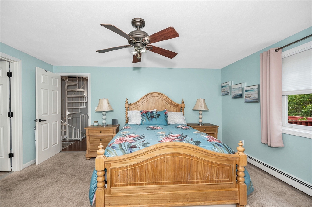 20 Chandler Drive, Unit 20 Atkinson, NH 03811 - Photo 16 of 33 a bedroom with a bed and a chandelier