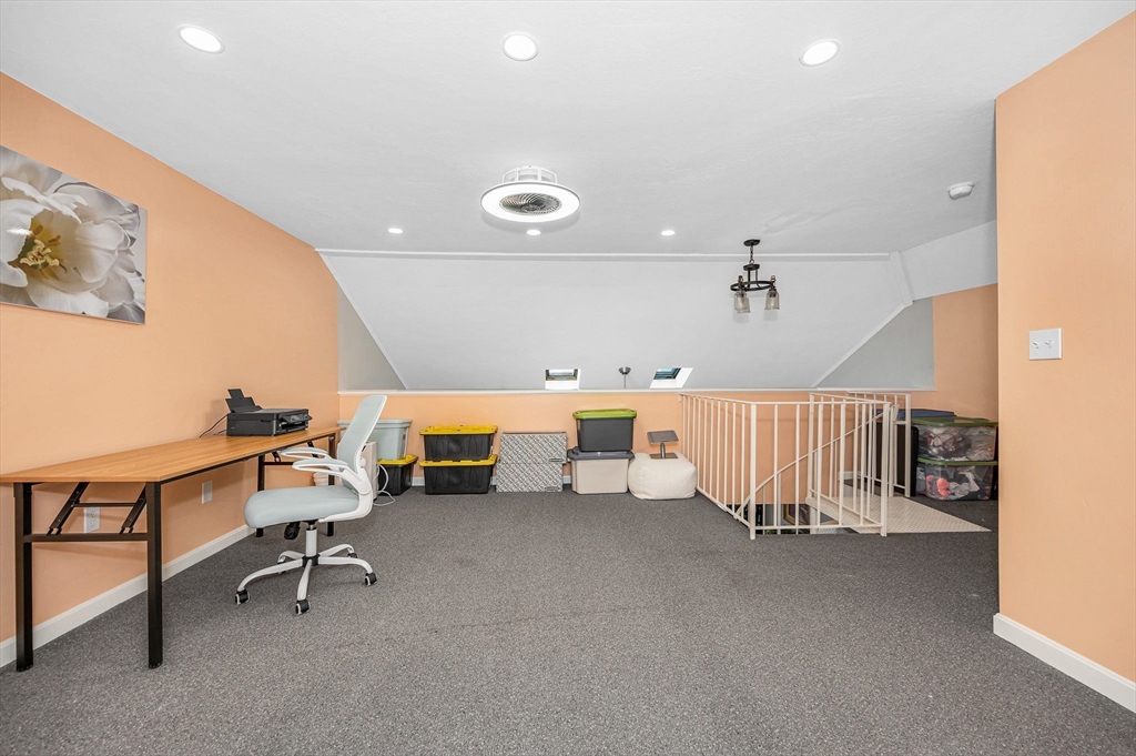 20 Chandler Drive, Unit 20 Atkinson, NH 03811 - Photo 20 of 33 a room with furniture and a chandelier