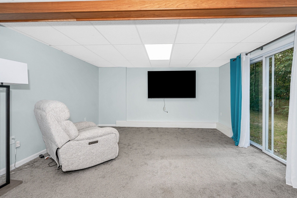 20 Chandler Drive, Unit 20 Atkinson, NH 03811 - Photo 22 of 33 a living room with furniture and a flat screen tv