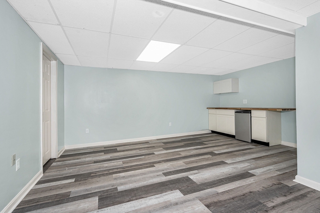 20 Chandler Drive, Unit 20 Atkinson, NH 03811 - Photo 27 of 33 a view of an empty room and wooden floor