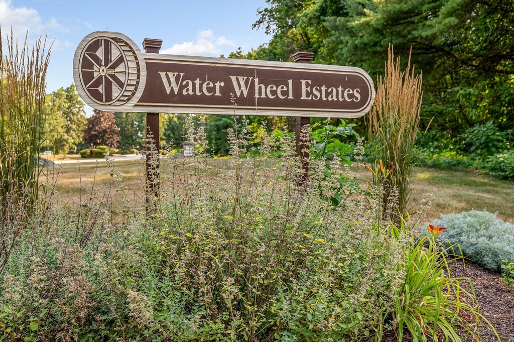 20 Chandler Drive, Unit 20 Atkinson, NH 03811 - Photo 30 of 33 a view of a sign under a tree