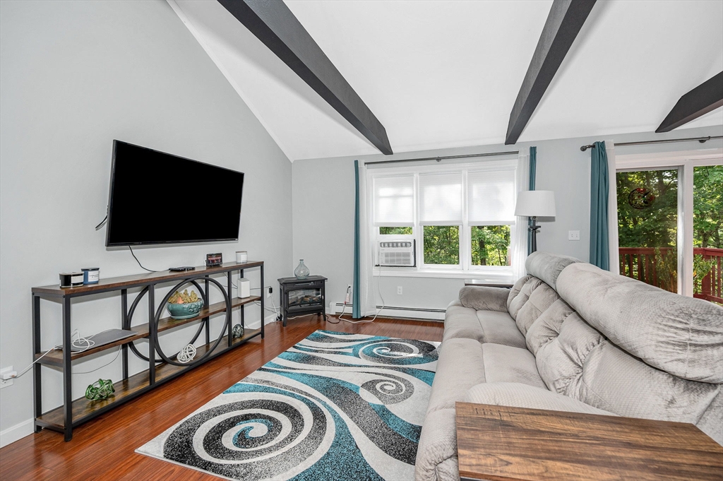 20 Chandler Drive, Unit 20 Atkinson, NH 03811 - Photo 9 of 33 a living room with furniture and a flat screen tv