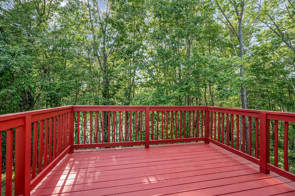20 Chandler Drive, Unit 20 Atkinson, NH 03811 - Photo 10 of 33 a balcony with wooden floor